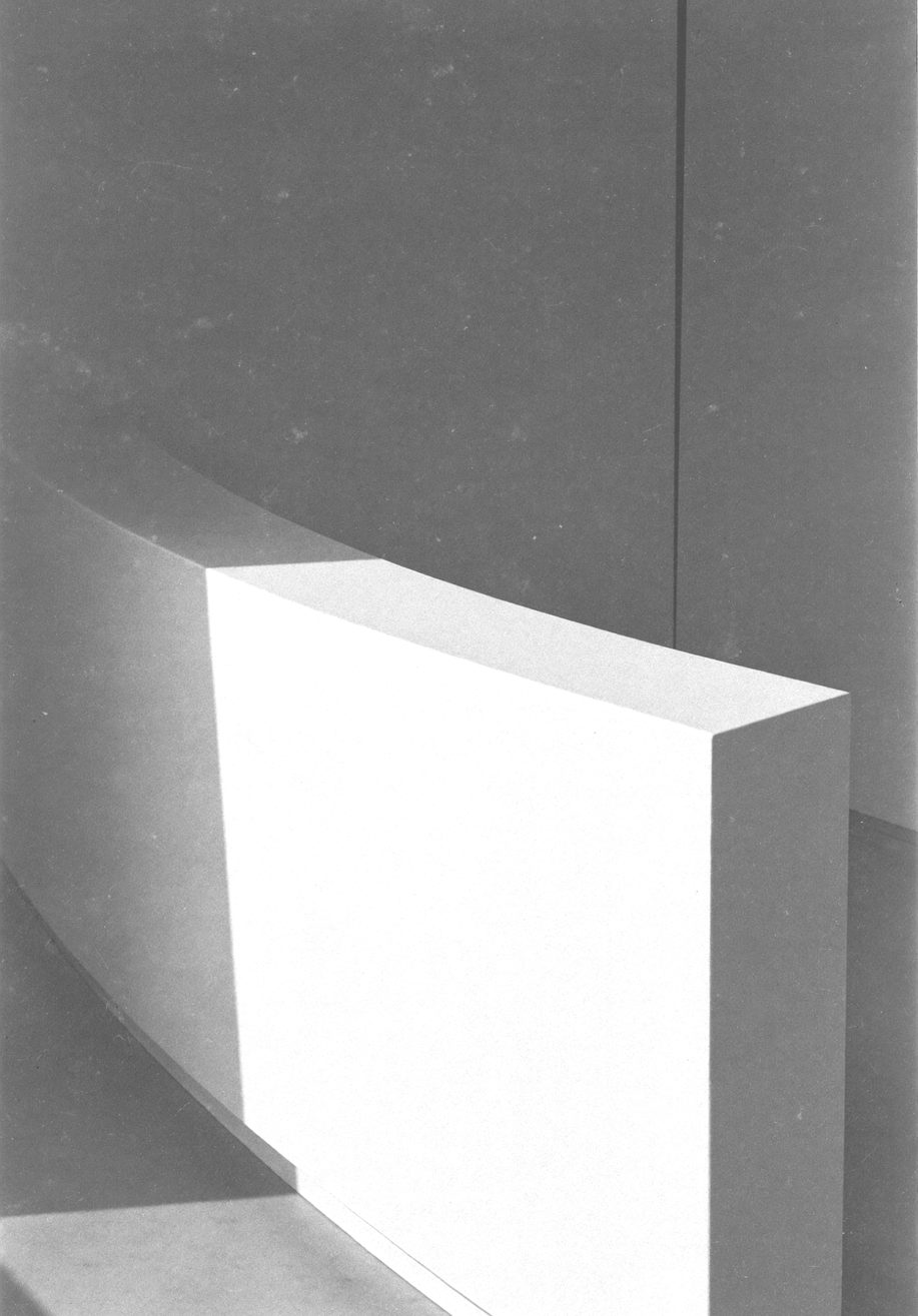 A minimal handbasin and tap in a clinical room, hard side light