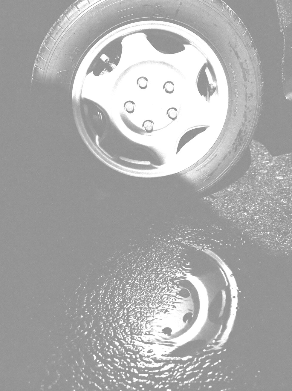 Interior detail of a steering wheel and dashboard, hard side light, leather texture, no dials