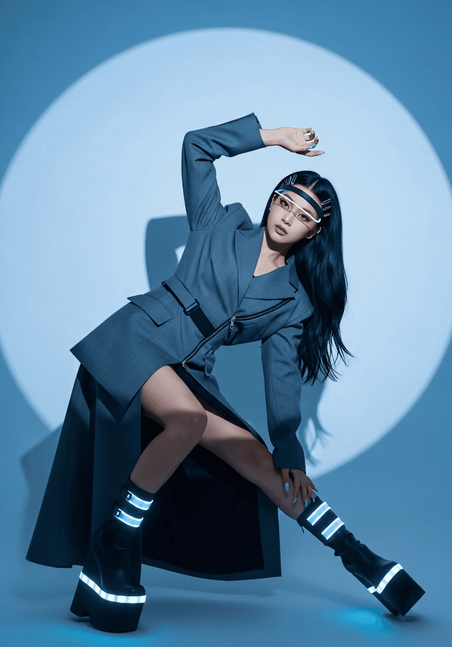 Editorial portrait in a structured blue coat against a blue background