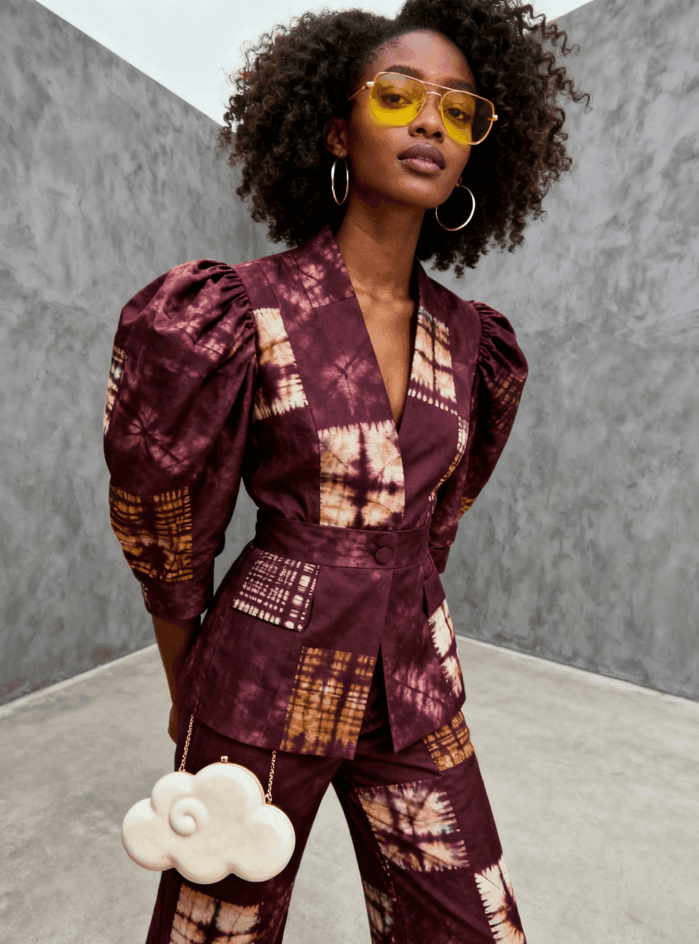 Woman in a patterned burgundy structured jacket